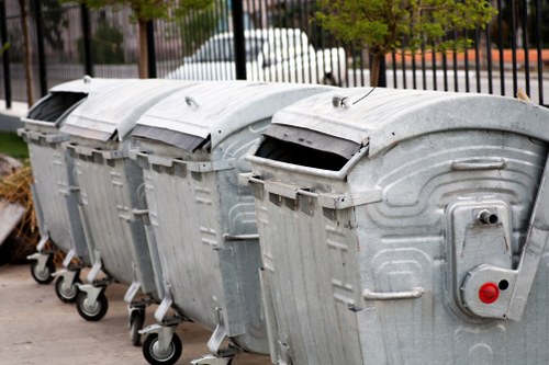 Front view of a commercial waste collection vehicle in service area