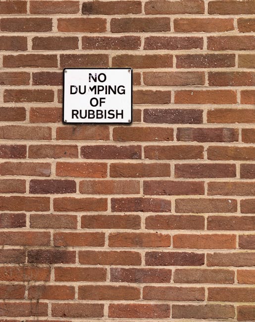 A black wheeled bin marked with white text reading 'COMMERCIAL WASTE ONLY' is positioned on the pavement in front of a brown-painted building housing a bar and restaurant. The bin is overflowing with 